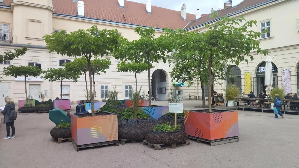 Bäume in großen bunten Pflanzkästen im Hof des Museumsquartiers
